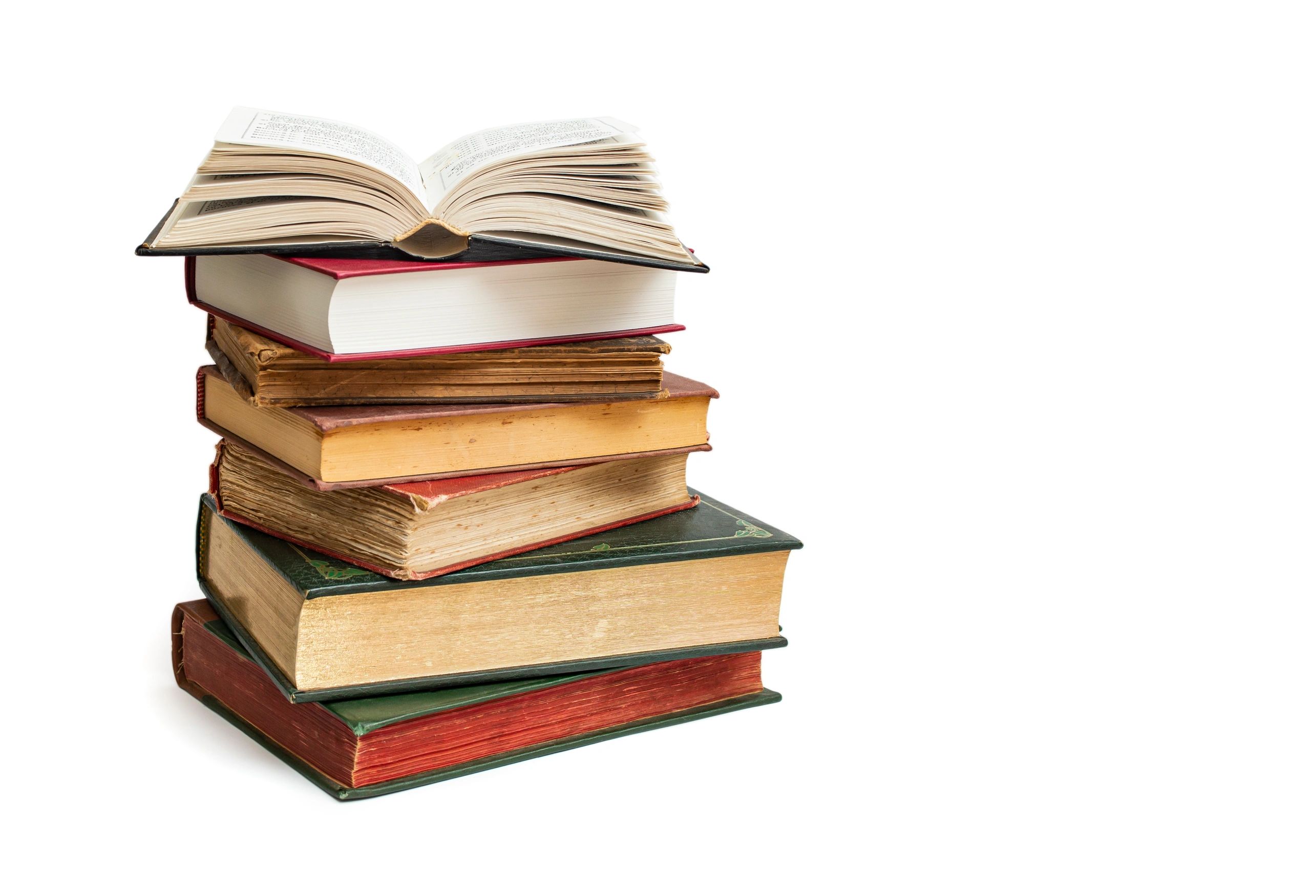 Stack of hardcover books with open book on top