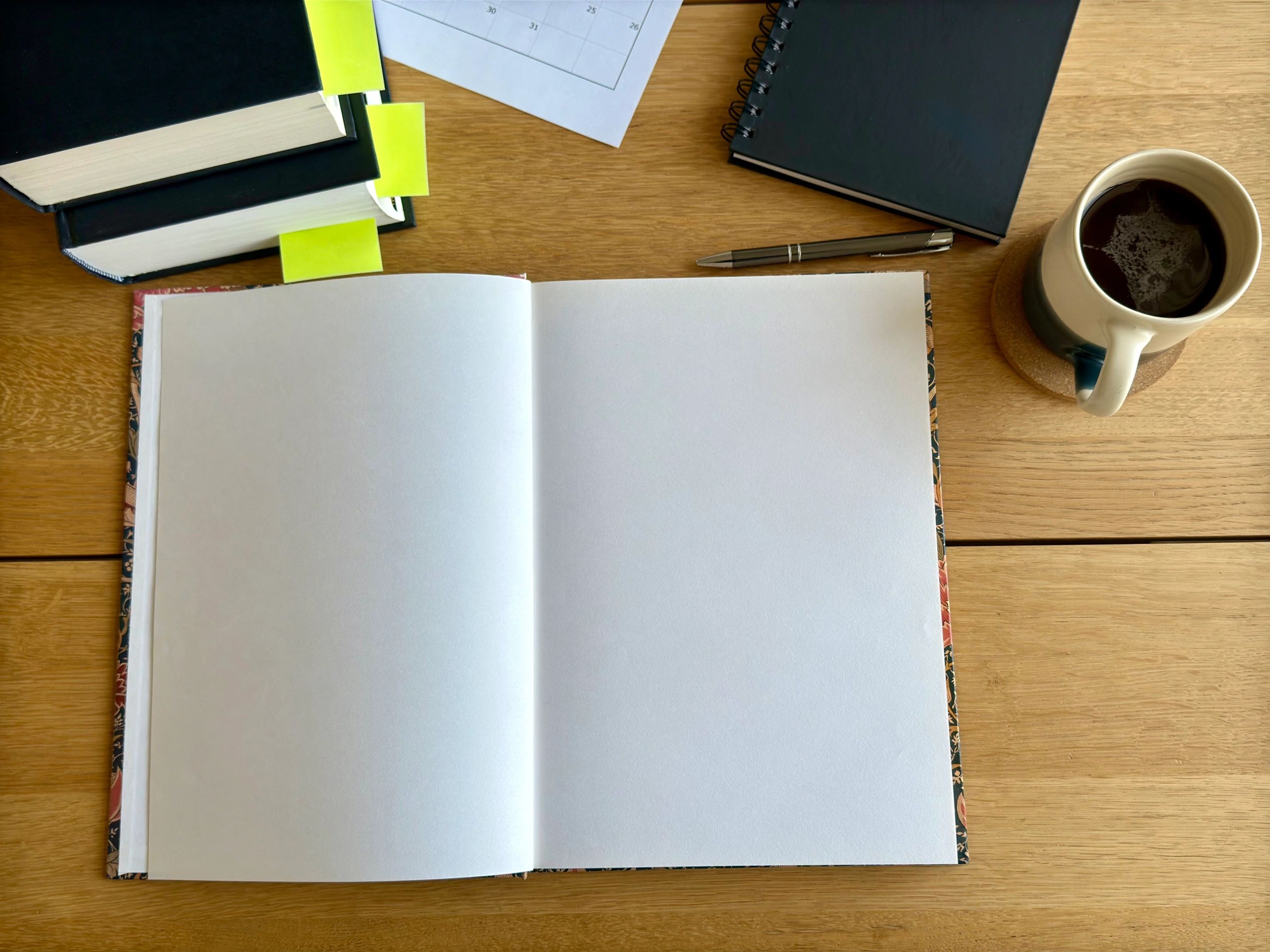 Open notebook and books on a desk