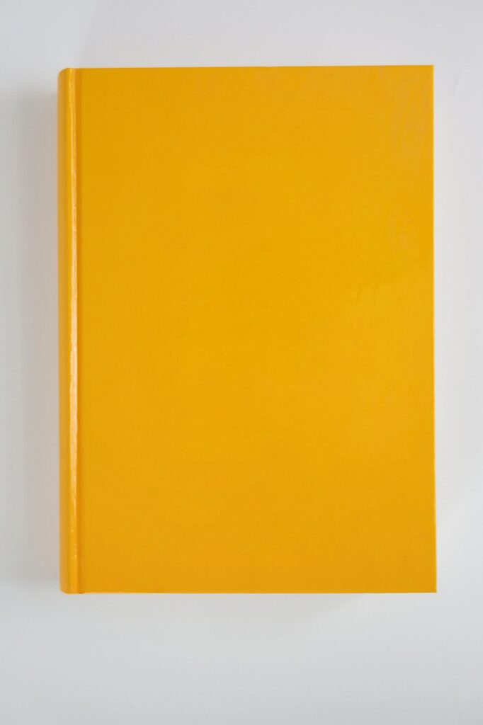 Yellow Book with Blank Cover on Light Background – Centered Top View as Mockup Template