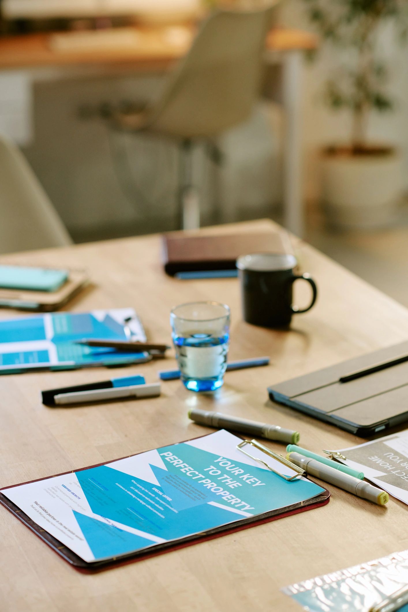 Business Documents and Digital Tablet Arranged on Office Desk during Meeting